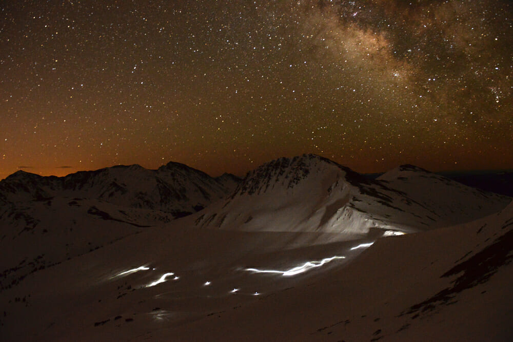 Headlamps light up an alpine section of the GT course during the long, hard, evening push through Colorado's Elk Range.