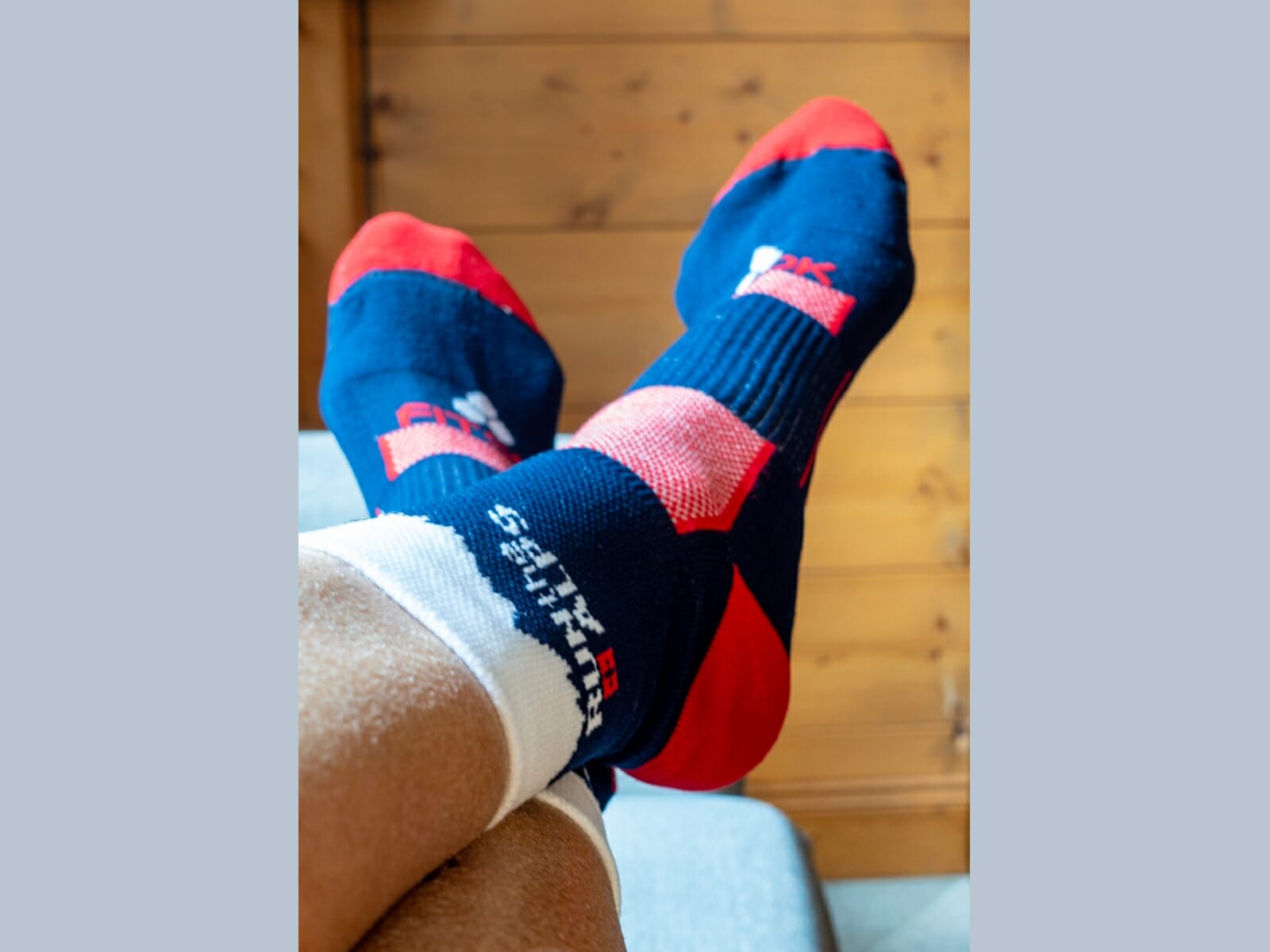 Feet with Run the Alps socks, dark blue, red and white