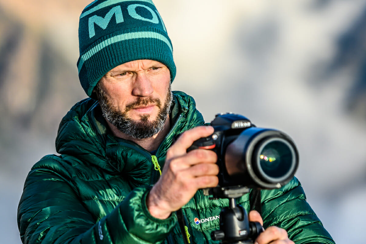 Mark Brightwell with green jacket and bonnet behind the lens