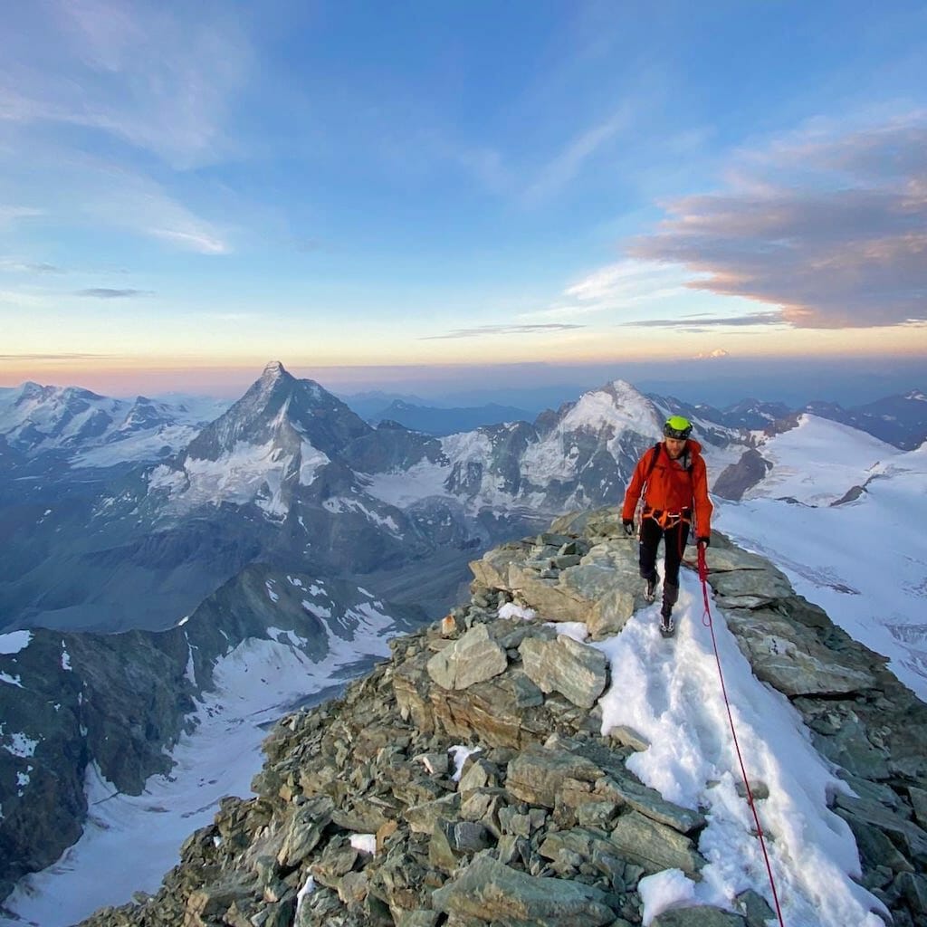 Grant Fulton in red jacket on the summit of the Dent Blanche