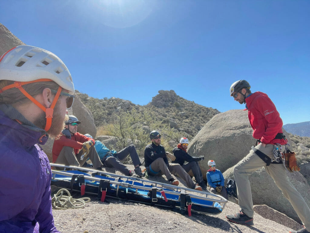 Mountain rescuers training with a rescue litter set up ready for use