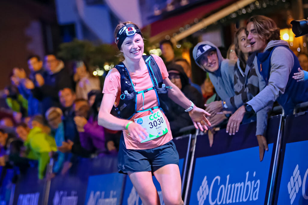 Katie Schide runs in to win CCC and passes by spectators in Chamonix, France.